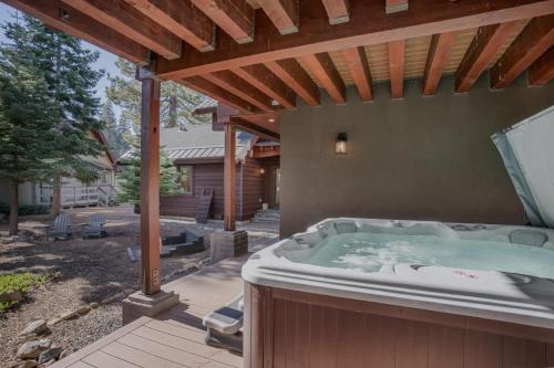 a hot tub under a pergola in a backyard at Stone Peak Lodge in Tahoe City