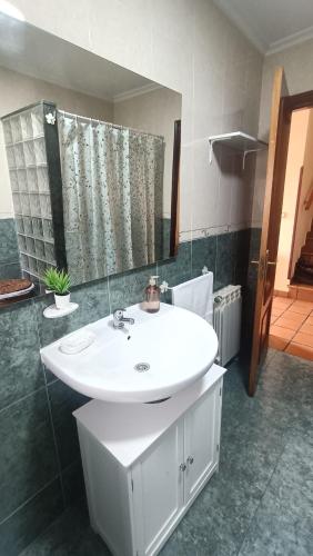 a bathroom with a white sink and a mirror at Casa Pepe La Granda in Trasona