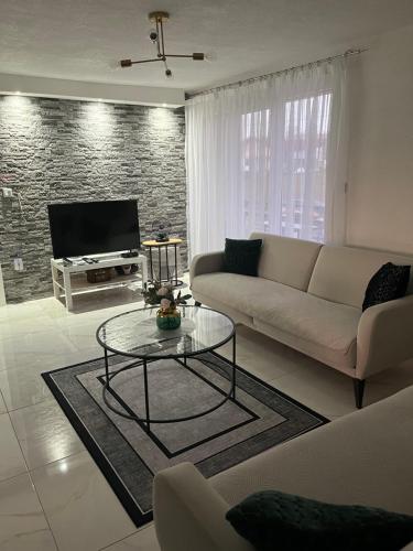 a living room with a couch and a table at Apartman Stari Grad in Cazin