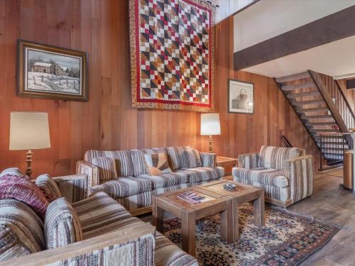 a living room with two couches and a table at Rooted Resort in Kings Beach