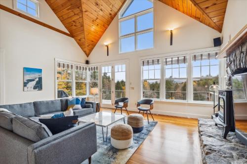 a living room with a couch and a tv at Weeks Hill Meadows in Stowe