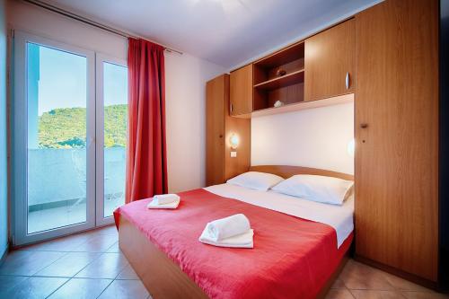 a bedroom with a bed with two towels on it at Apartments Bruna in Lastovo