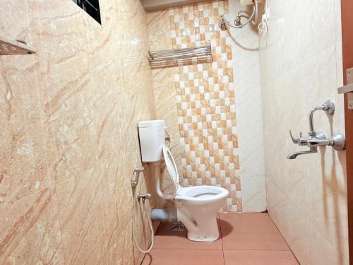 a bathroom with a toilet and a shower at Century Regency in Cochin