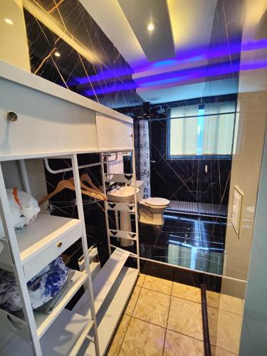 a bathroom with purple lights on the ceiling at Height 909 Hostal in Juayúa