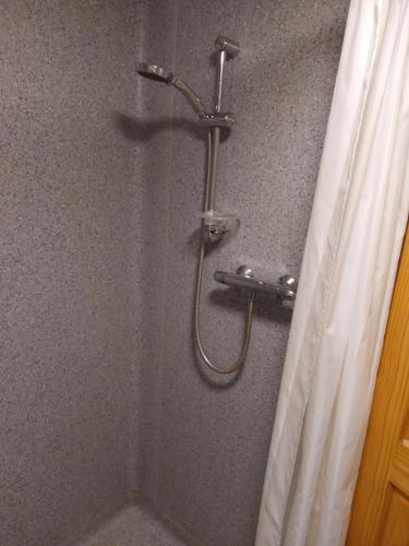 a shower in a bathroom with a shower curtain at Bellevue Inn in Saint Margarets Hope