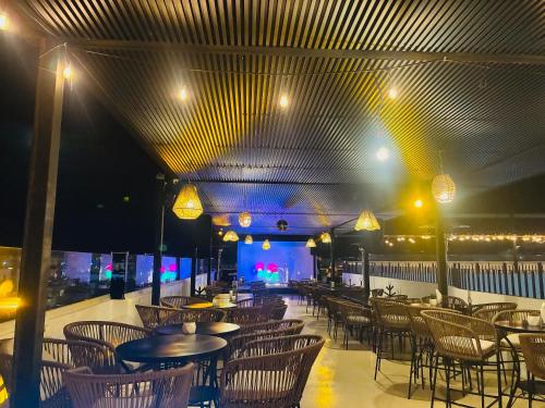 a restaurant with tables and chairs and lights at Hotel Palmeras Los Cabos in Cabo San Lucas
