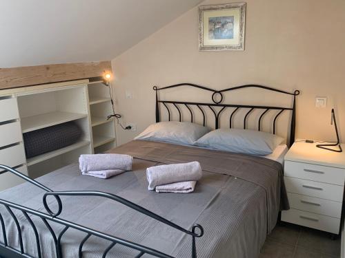 a bedroom with a bed with two pillows on it at Beach apartment Kostrena 2 in Kostrena
