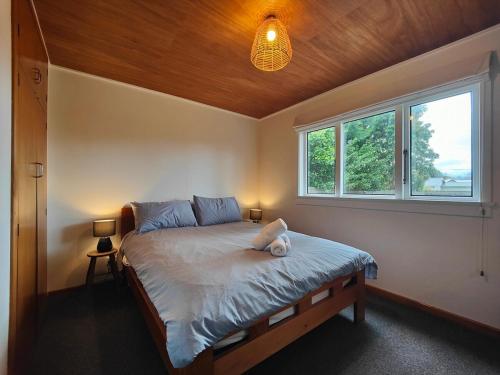 a bedroom with a large bed with a window at Arrive and Revive Te Anau in Te Anau
