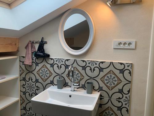 a bathroom with a sink and a mirror at Beach apartment Kostrena 2 in Kostrena