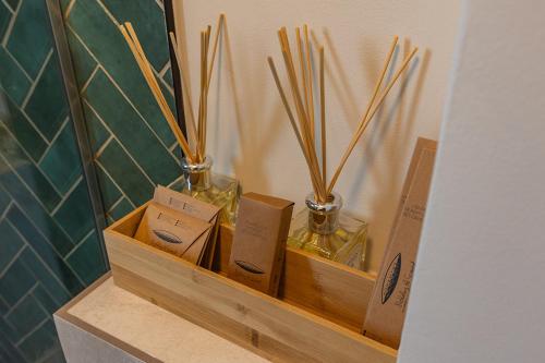 two glass vases sitting on a shelf with boxes at Habitat Suites III in Craiova