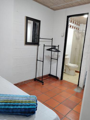 a room with a bathroom with a toilet and a mirror at Los Arrieros - Hospedaje Rural in Manizales