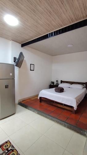 a bedroom with a bed and a tv in a room at Los Arrieros - Hospedaje Rural in Manizales