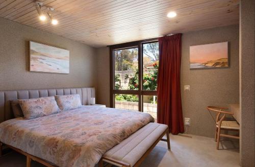 a bedroom with a large bed and a window at Retro Reservoir Retreat in Kennington