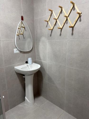 a bathroom with a sink and a mirror on the wall at Casa vermelha Recanto Doce Lar in Gravatá