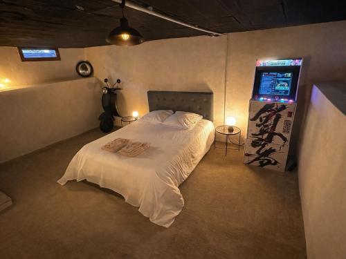 a bedroom with a white bed and a window at Jacuzzi et cinéma privatif P1 in Pessac