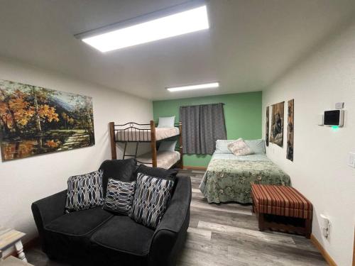 a living room with a bed and a couch and a bedroom at Cozy Little Dipper in North Pole
