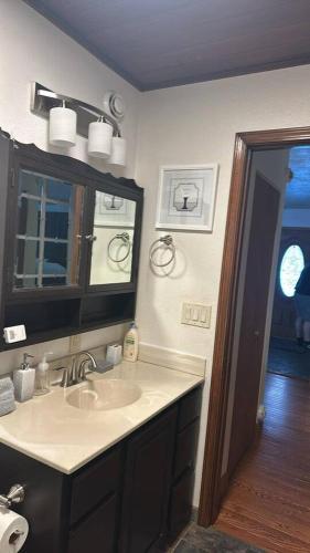 a bathroom with a sink and a mirror at Cozy Little Dipper in North Pole