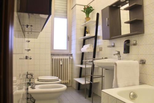 a bathroom with a toilet and a sink at Iconic 3-BR Home Steps from Duomo in Milan