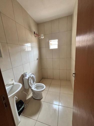 a small bathroom with a toilet and a sink at Barbosa in Três Marias