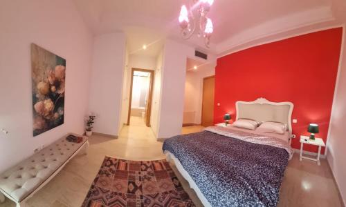 a bedroom with a red wall and a large bed at Appartement de luxe in Sidi Daoud