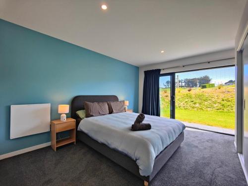 a bedroom with a large bed and a large window at Rack n Relax Riverton in Riverton