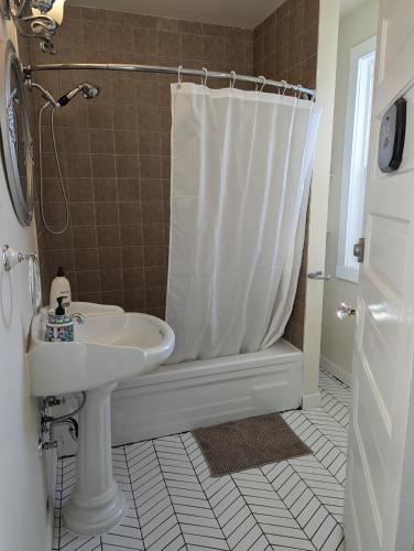 a bathroom with a sink and a shower at Charles Street Vacation Home in Lethbridge