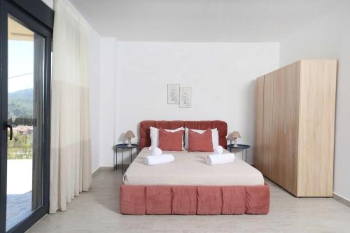 a bedroom with a bed with two pillows on it at Hilltop Apartment 6 in Hanioti
