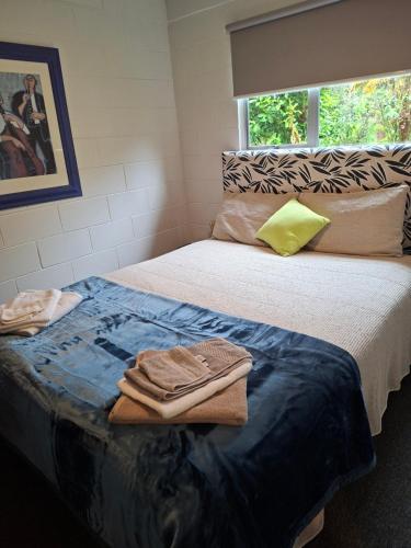 a bedroom with two beds with towels on it at Bach on Waikawa 2 bedroom home in Picton
