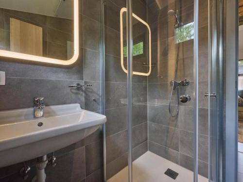 a bathroom with a shower and a sink at Cabin 22 in Zutendaal