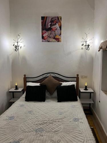 a bedroom with a large bed with two night stands at Riad Dar khadija in Taroudant