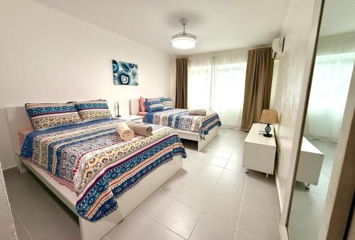 a bedroom with two beds and a window at Palm Paradise Condo Pool & Beach in Punta Cana