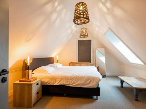 a bedroom with a large bed in a attic at Villa Kaagervaaring in Kaag