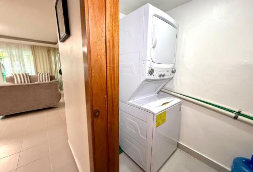 a refrigerator with a washer and dryer in a room at Palm Paradise Condo Pool & Beach in Punta Cana