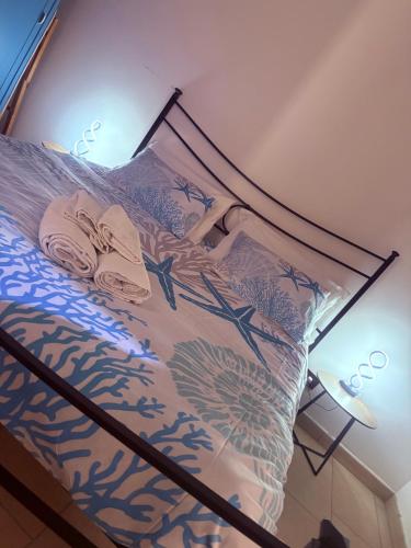 a bedroom with a bed with a bedspread with flowers at Vista mare Fiumicino-Beach&Fly Stay in Fiumicino