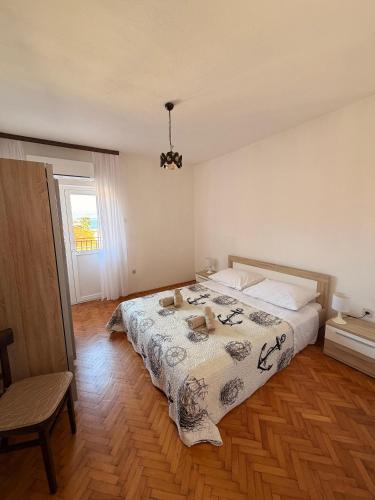 a bedroom with a bed with two teddy bears on it at Apartments by the sea Ugljan - 8264 in Ugljan