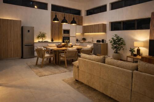 a kitchen and living room with a table and chairs at Fairview Holiday Villa in Rivière Noire