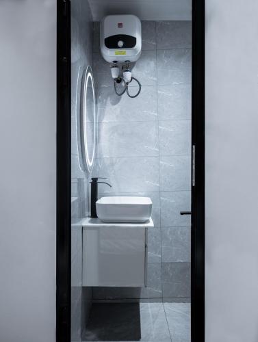 a bathroom with a white sink and a mirror at Aiidraproperties in Lagos