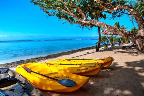 a group of yellow boats parked on a beach at Maui Palms in Korolevu