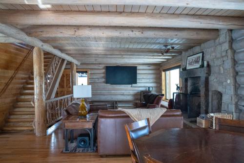 a living room with a couch and a fireplace at Trappers Cabin in Beaver Creek