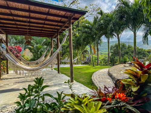 a resort with a hammock in a garden at Villa Tayrona in El Zaino