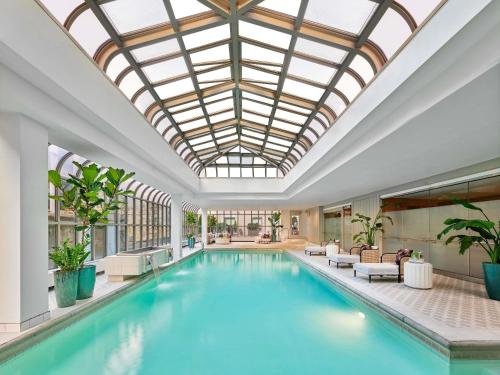 an indoor pool with a skylight and a pool house with furniture at Fairmont Olympic Hotel in Seattle