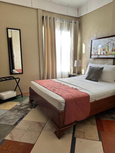 a bedroom with a large bed with a window at Villa Gabriela, Casa Tucan in Liberia