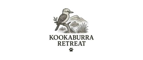 a bird sitting on a branch with a mountain in the background at Kookaburra Retreat in Halls Gap