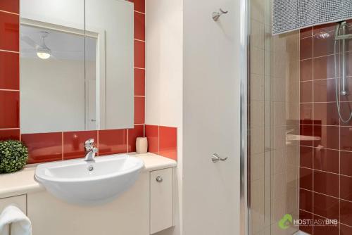 a bathroom with a white sink and a shower at Phillip Island Resort Villa 148 Amazing Views in Cowes