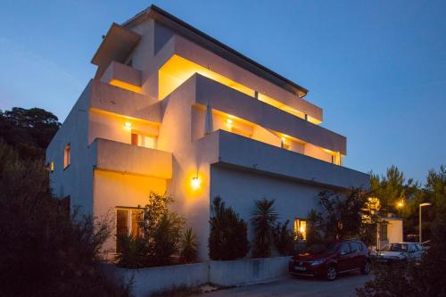 a building with a car parked in front of it at Apartments Bruna in Lastovo