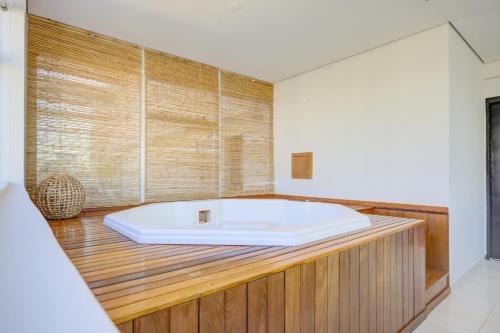 a bathroom with a large white tub on a wooden counter at Park Inn by Radisson Berrini in São Paulo