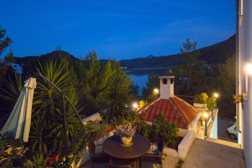 a view of a balcony with a table and chairs at Apartments Bruna in Lastovo