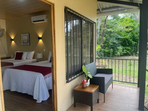 a bedroom with a bed and a balcony with a view at Cabañas y Senderos Finca El Triunfo in Los Chiles