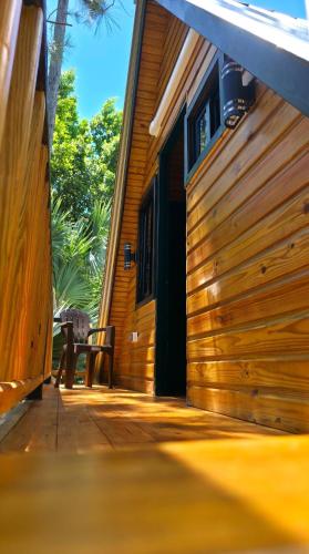 a wooden house with a bench in front of it at Cumbre Verde Alpine Villa in Monción