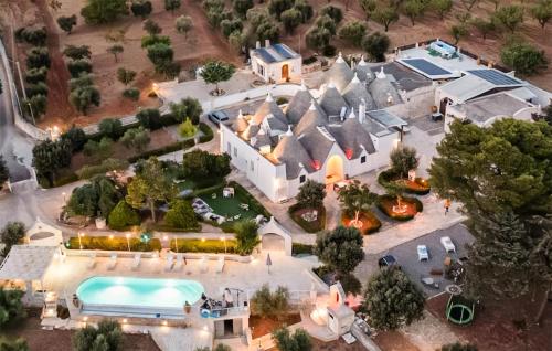 an aerial view of a house with a pool at Masseria Carperi in Cisternino